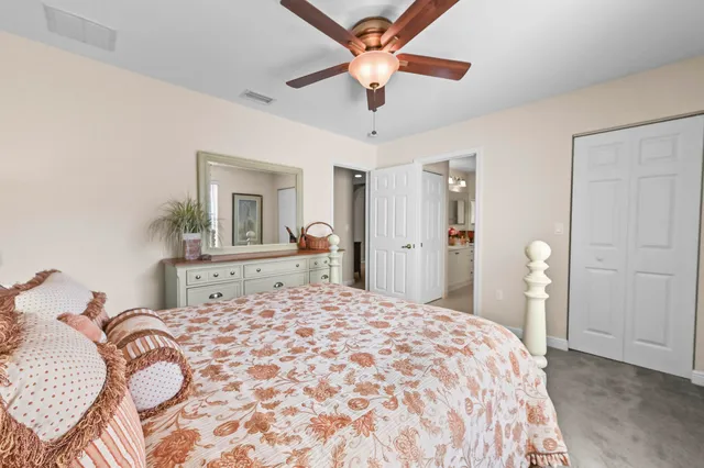 a bedroom with a large bed and a chandelier