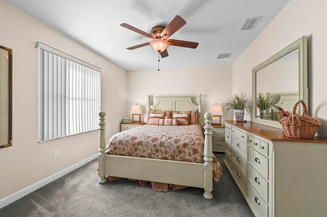a bedroom with a bed and ceiling fan
