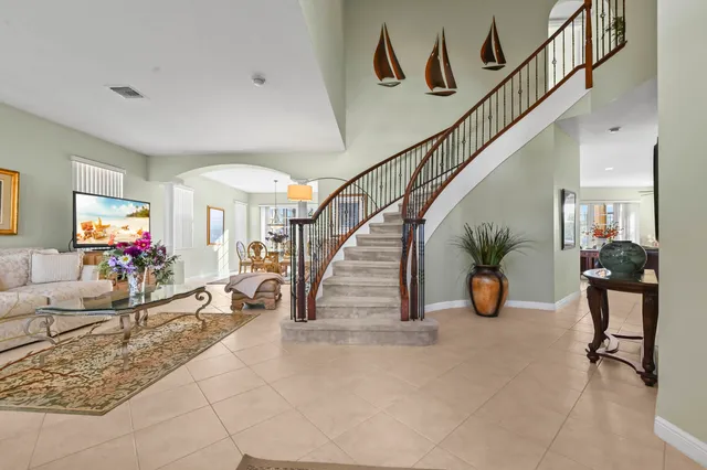 a living room with furniture and stairs