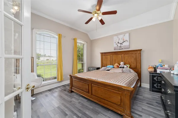 a bedroom with a bed and wooden floor