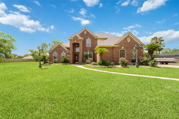 a front view of house with yard and green space