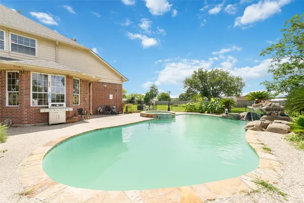 a view of a swimming pool with sitting area