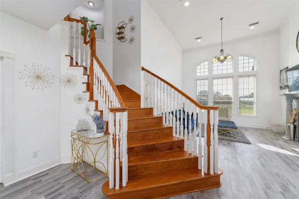 a view of entryway and hall with wooden floor