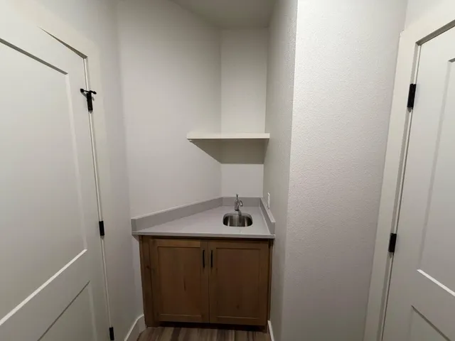 a view of a bathroom with a sink and a mirror