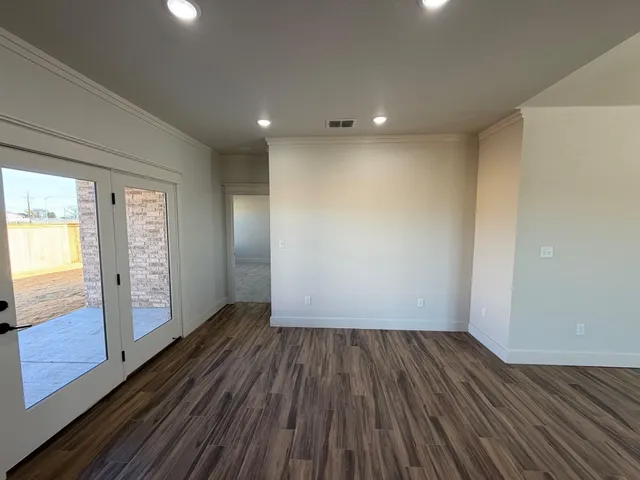 a view of a hallway with wooden floor