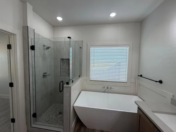 a bathroom with a bathtub and a shower