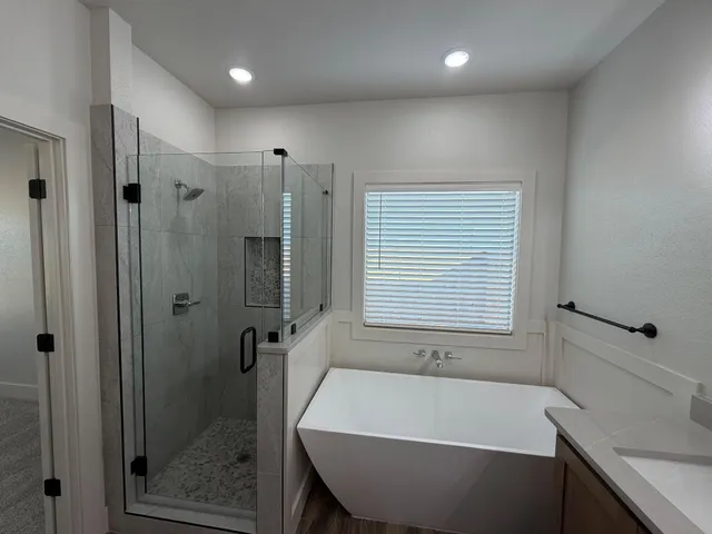 a bathroom with a bathtub and a shower