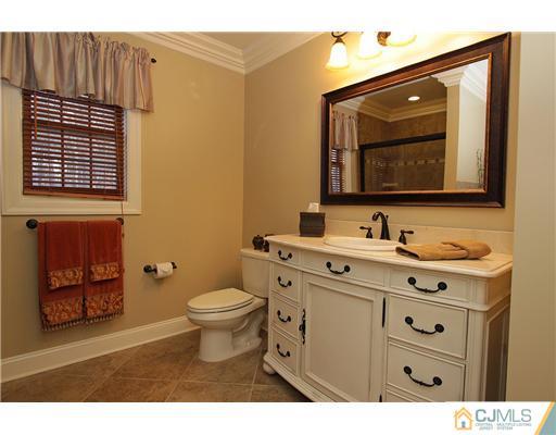 32 South Rhoda Street Monroe Township, NJ 08831 - Photo 11 of 20 a bathroom with a toilet sink vanity and mirror