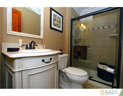 32 South Rhoda Street Monroe Township, NJ 08831 - Photo 15 of 20 a bathroom with a sink a toilet a mirror and shower