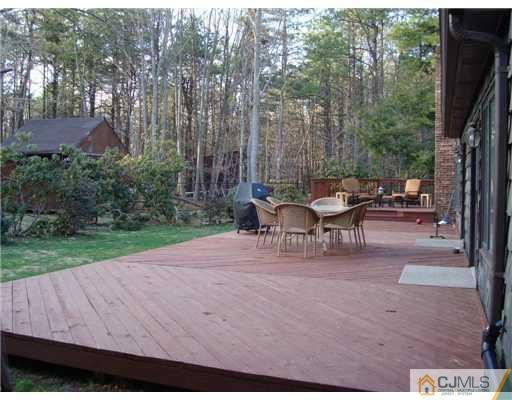 32 South Rhoda Street Monroe Township, NJ 08831 - Photo 17 of 20 a view of a patio with table and chairs and garden