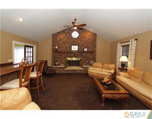 32 South Rhoda Street Monroe Township, NJ 08831 - Photo 6 of 20 a living room with furniture a rug and a chandelier