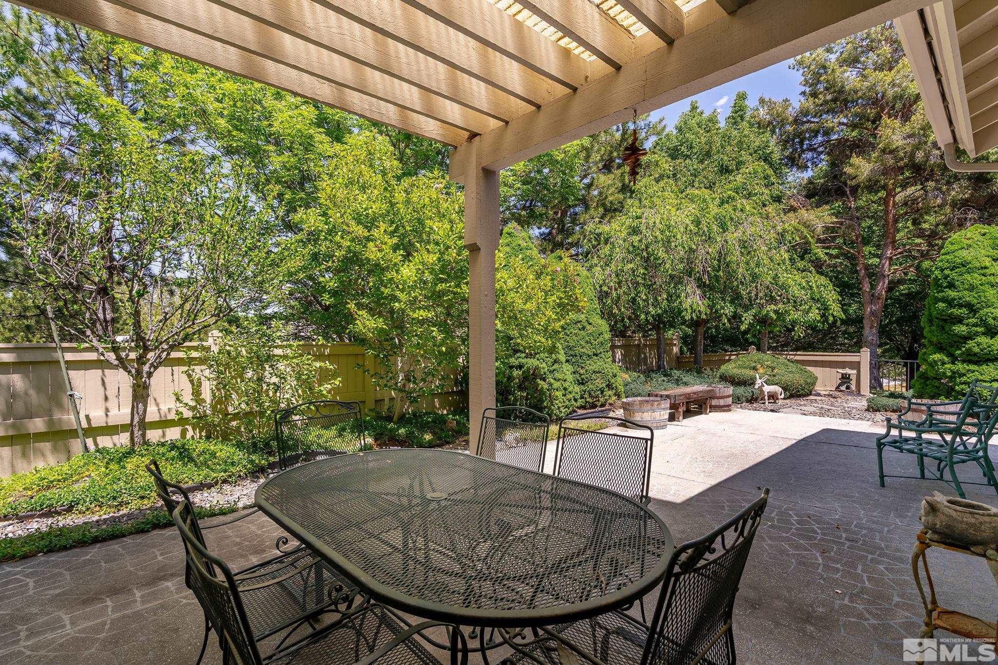 3835 Chinook Creek Road Reno, NV 89519 - Photo 22 of 29 a view of patio with table and chairs and potted plants