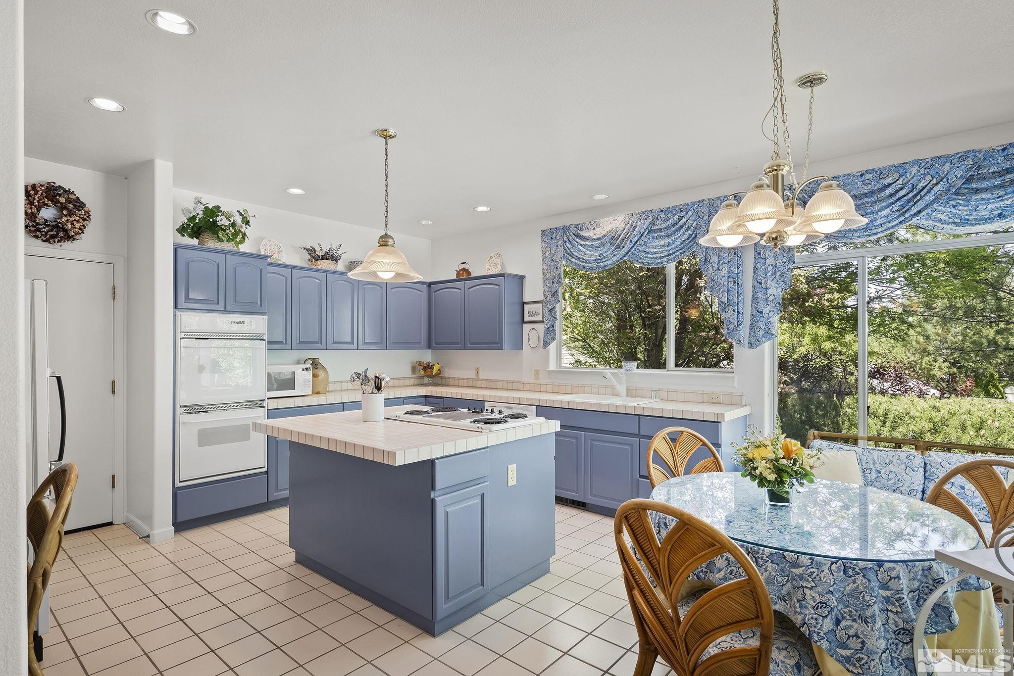 3835 Chinook Creek Road Reno, NV 89519 - Photo 6 of 29 a kitchen that has a stove a table and chairs in it