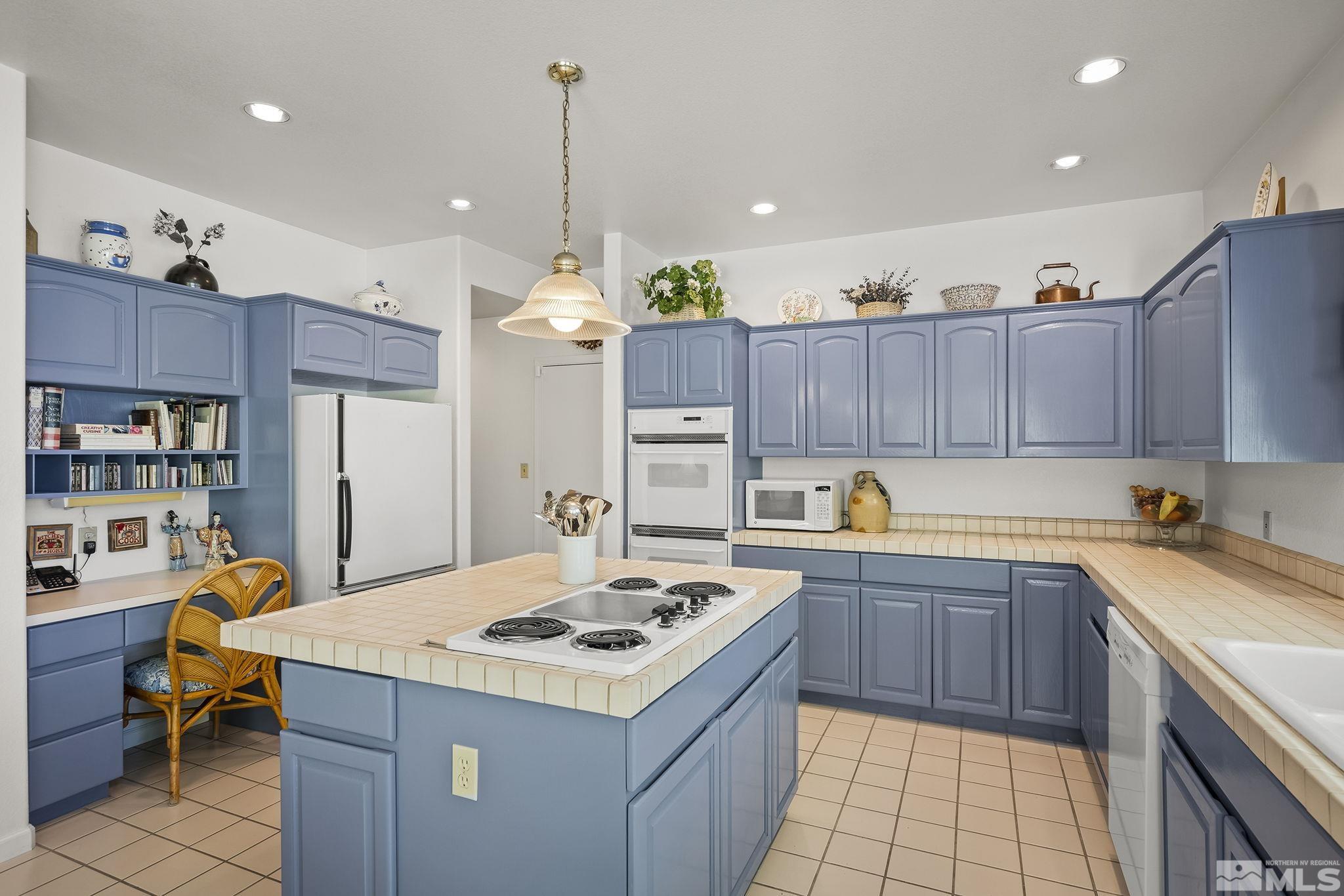 3835 Chinook Creek Road Reno, NV 89519 - Photo 8 of 29 a kitchen with a sink a stove a refrigerator and wooden cabinets