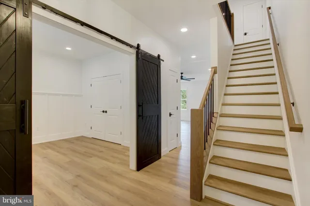 a view of entryway with wooden floor and windows