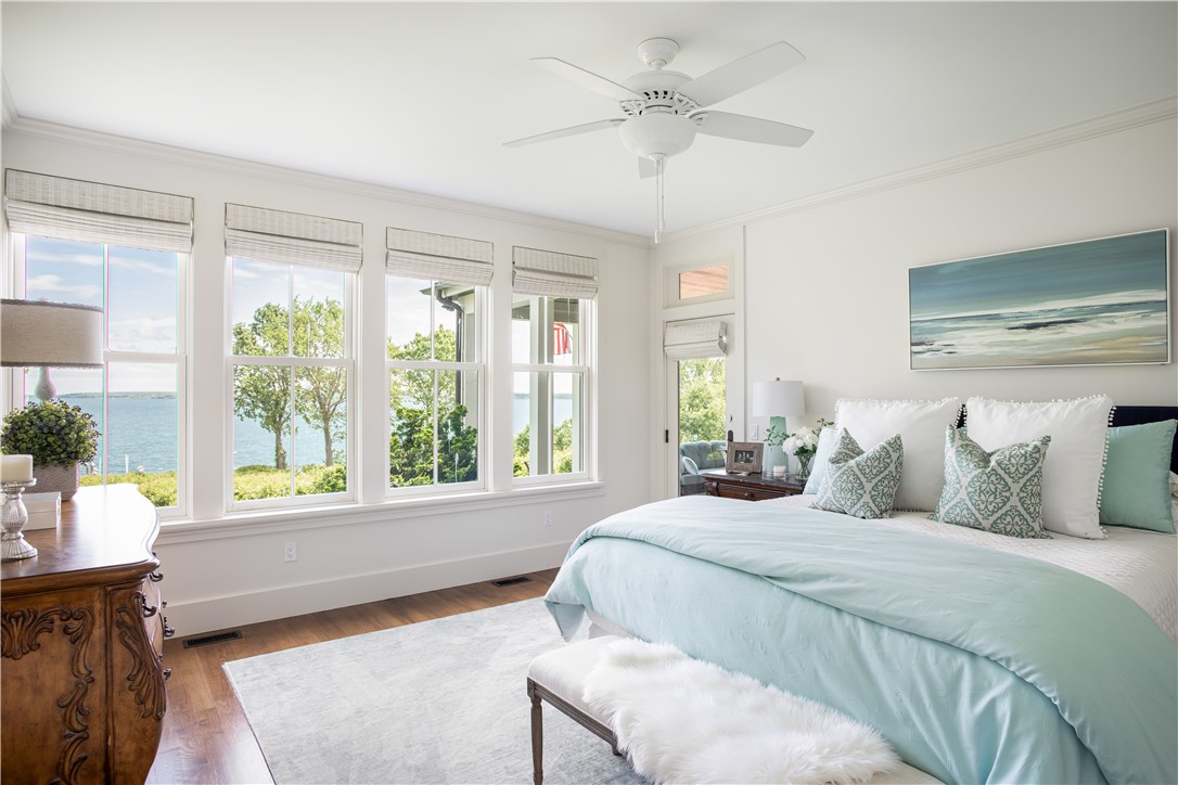 1088 East Shore Road Jamestown, RI 02835 - Photo 25 of 50 1st floor ensuite Master bedroom with access to fieldstone terrace and fireplace