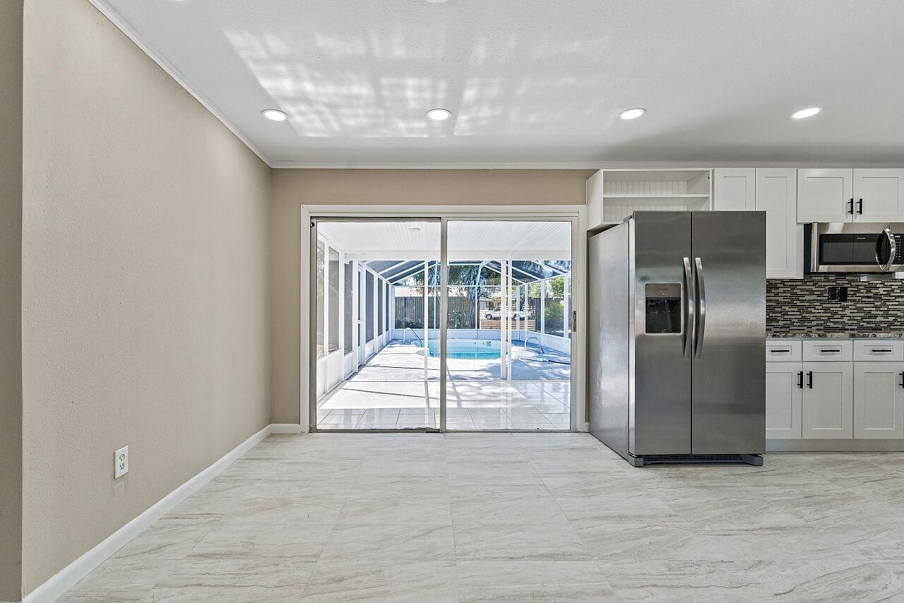111 Alameda Avenue Sebastian, FL 32958 - Photo 13 of 33 a view of a kitchen with a sink and a refrigerator
