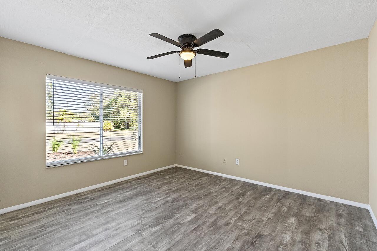 111 Alameda Avenue Sebastian, FL 32958 - Photo 15 of 33 wooden floor in an empty room with a window