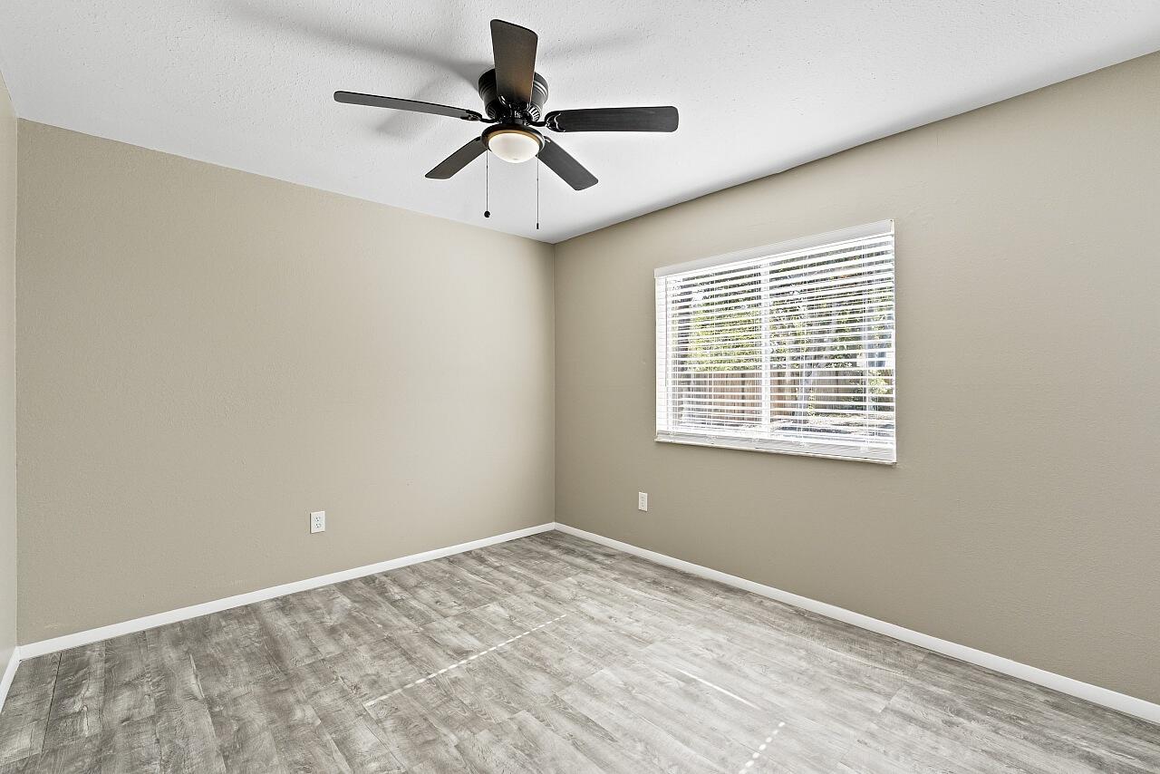 111 Alameda Avenue Sebastian, FL 32958 - Photo 21 of 33 a view of a big room with wooden floor and windows