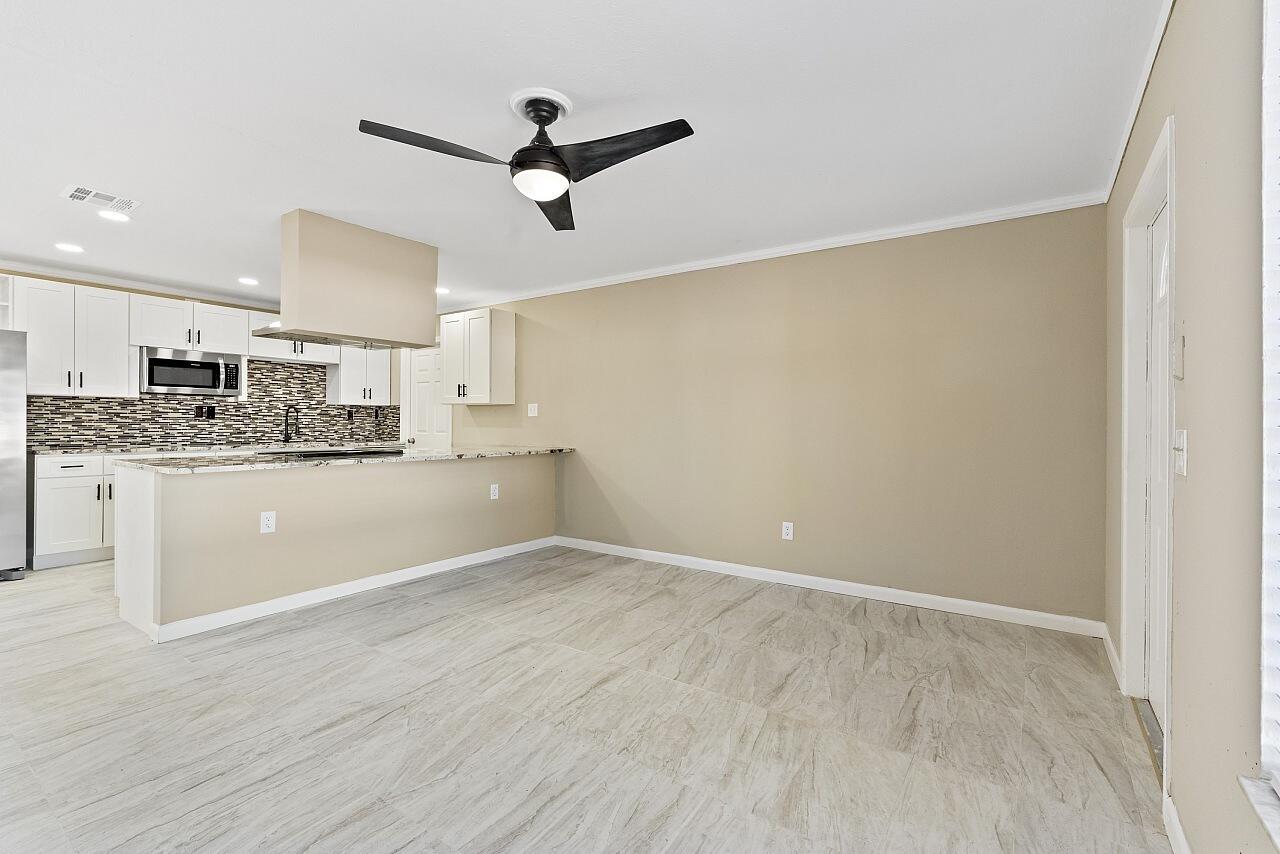 111 Alameda Avenue Sebastian, FL 32958 - Photo 6 of 33 a view of a kitchen with a sink and dishwasher a refrigerator with wooden floor