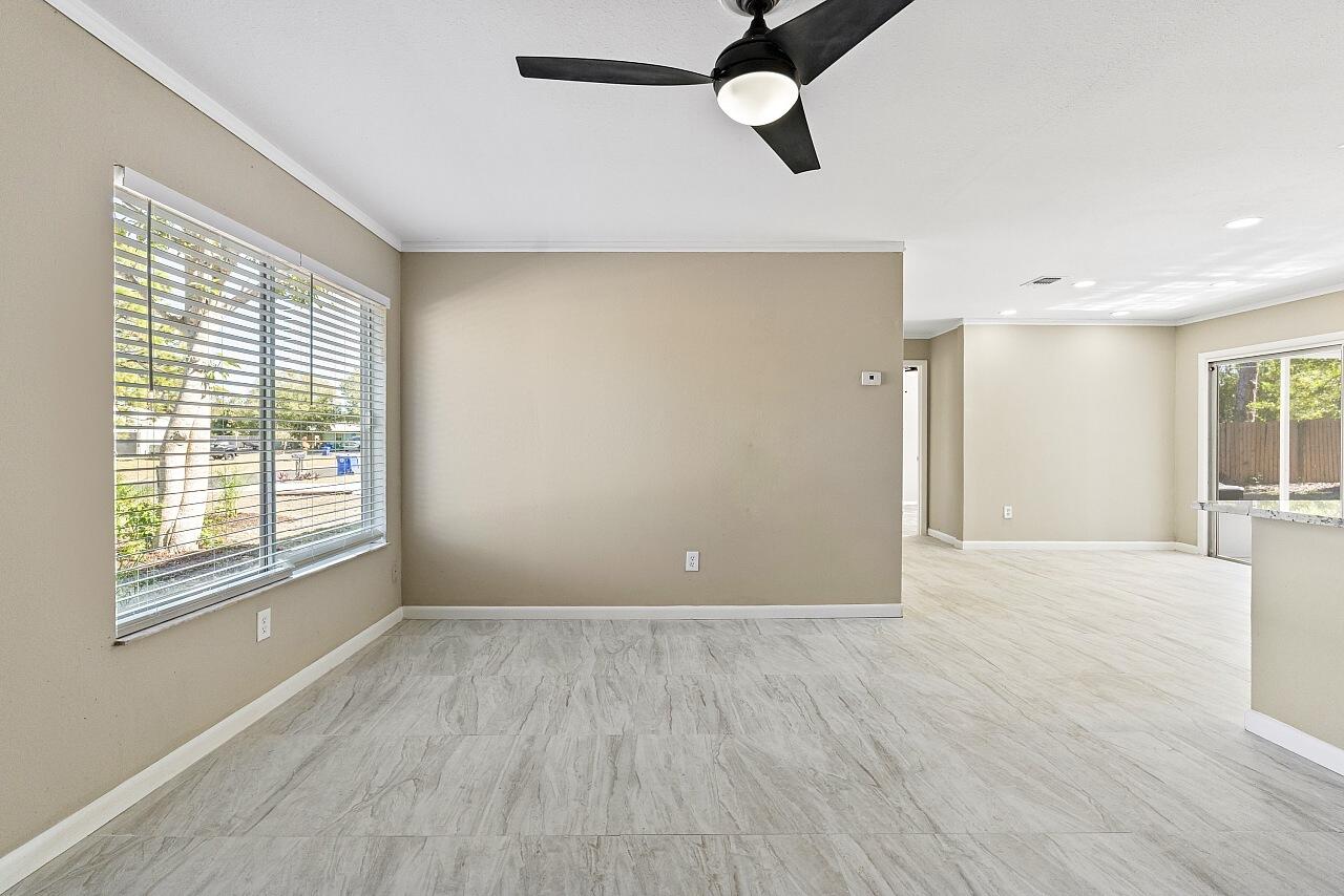111 Alameda Avenue Sebastian, FL 32958 - Photo 7 of 33 a view of an empty room with window and wooden floor
