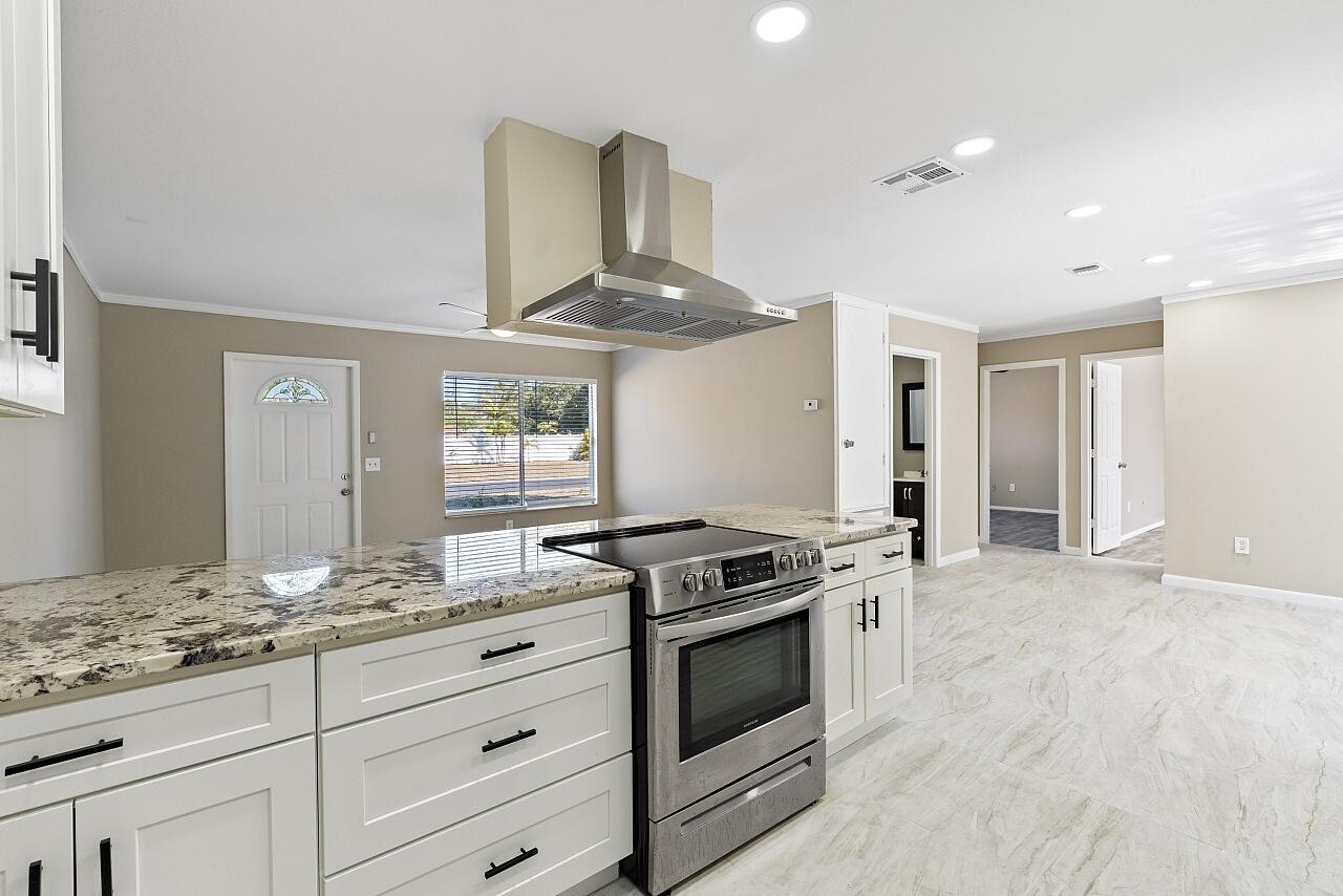 111 Alameda Avenue Sebastian, FL 32958 - Photo 10 of 33 a kitchen with granite countertop a stove and a sink