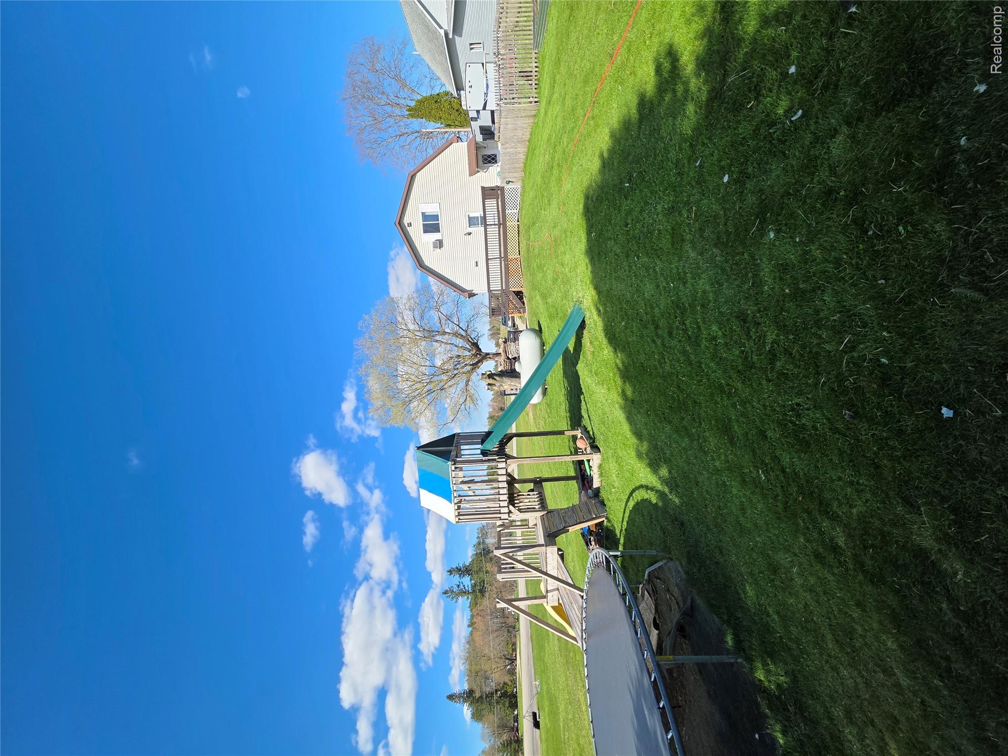 5847 F Road Bark River, MI 49807 - Photo 20 of 25 View of yard featuring a trampoline and a playground