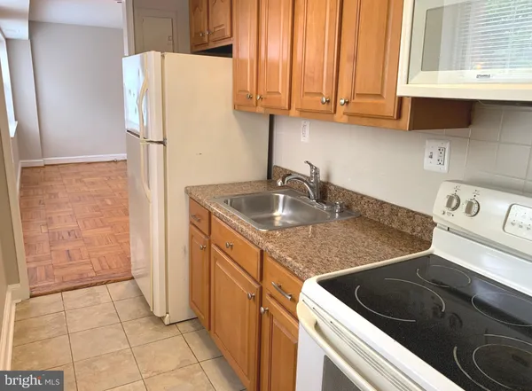 a kitchen with a sink cabinets and a refrigerator
