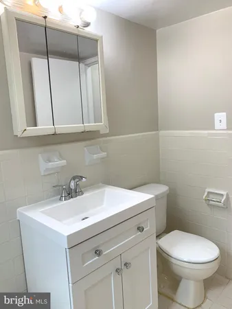 a bathroom with a sink a toilet and mirror