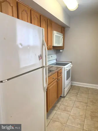 a kitchen with stainless steel appliances a refrigerator sink and cabinets