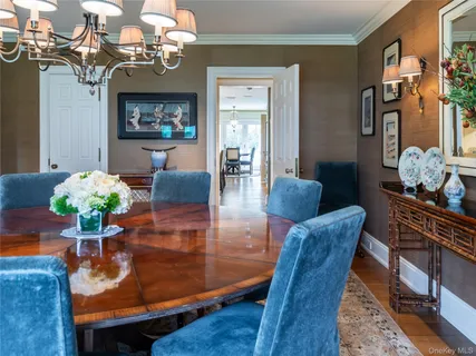 a view of a dining room with furniture and chandelier