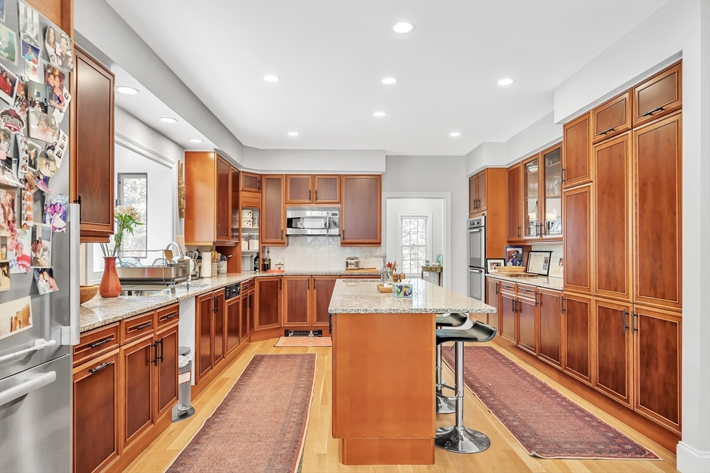 34 Solomon Pierce Road Lexington, MA 02420 - Photo 13 of 42 a large kitchen with stainless steel appliances lots of counter top space and windows