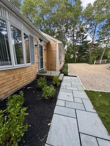 a kitchen with stainless steel appliances granite countertop wooden cabinets a granite counter tops and a large window