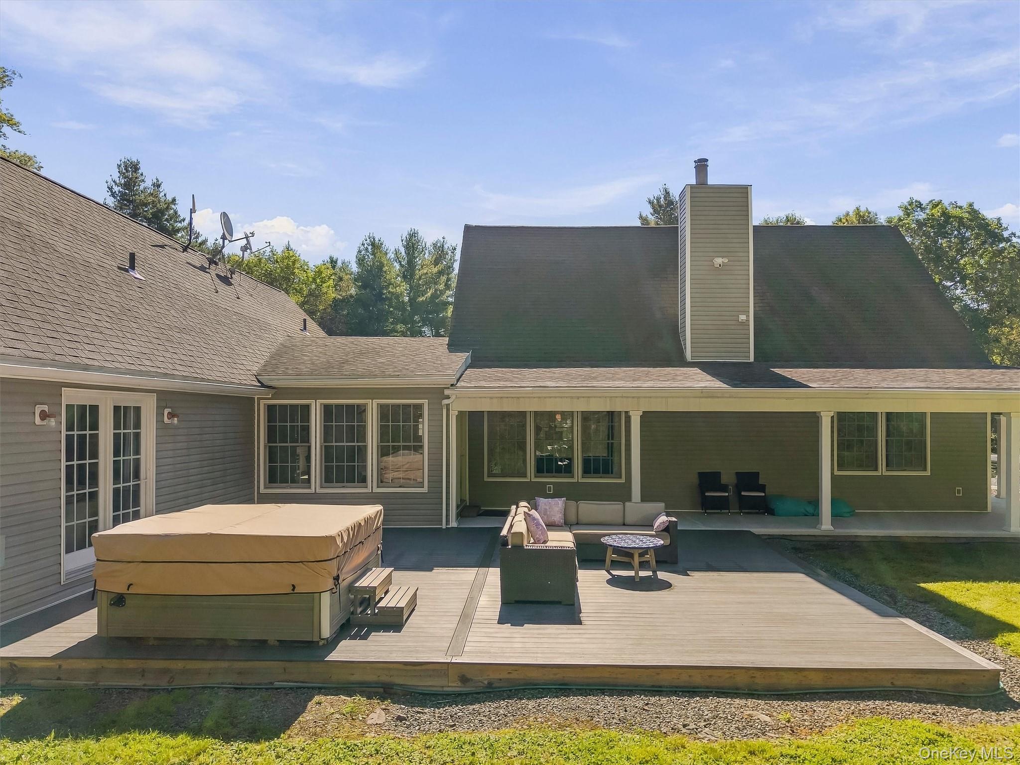 705 Swamp Pond Road Narrowsburg, NY 12764 - Photo 36 of 49 back yard deck with hot tub and lounge area