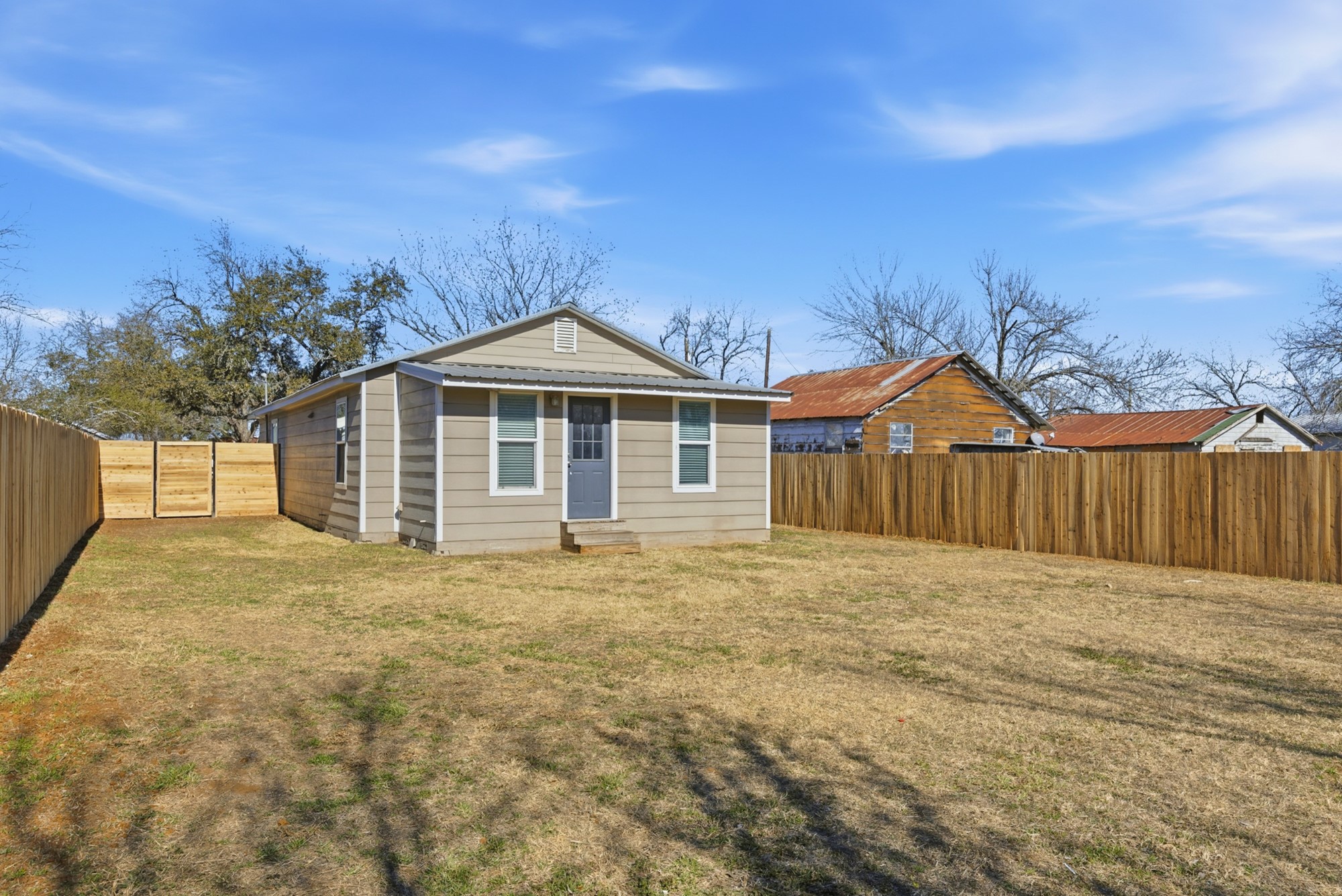 108 Irene Street Elgin, TX 78621 - Photo 27 of 29 Rear view of house featuring a fenced backyard