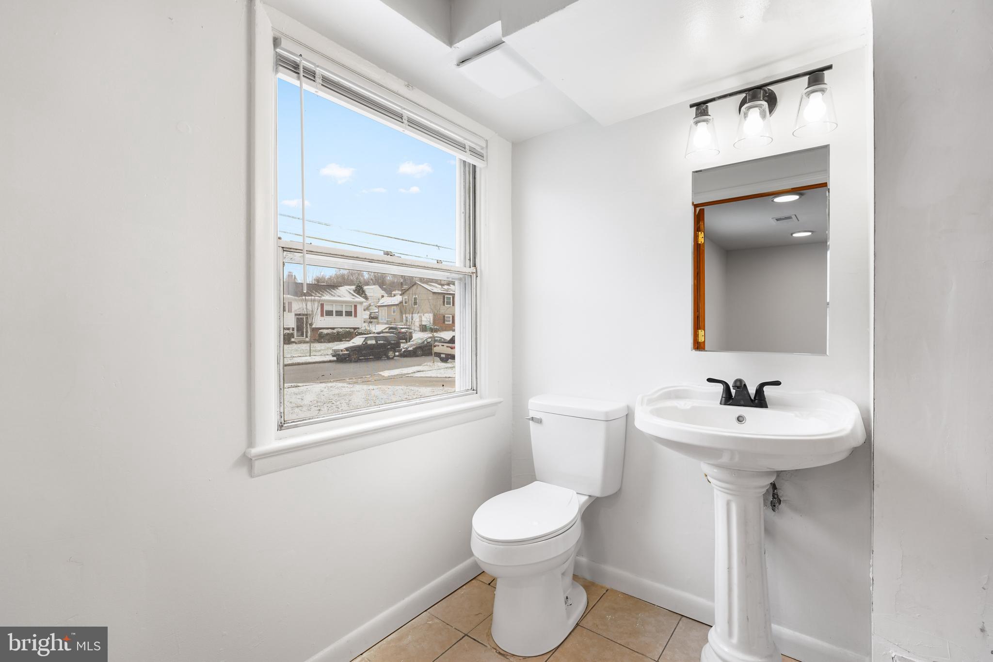 6903 Fawncrest Drive Capitol Heights, MD 20743 - Photo 11 of 36 a bathroom with a sink mirror and toilet