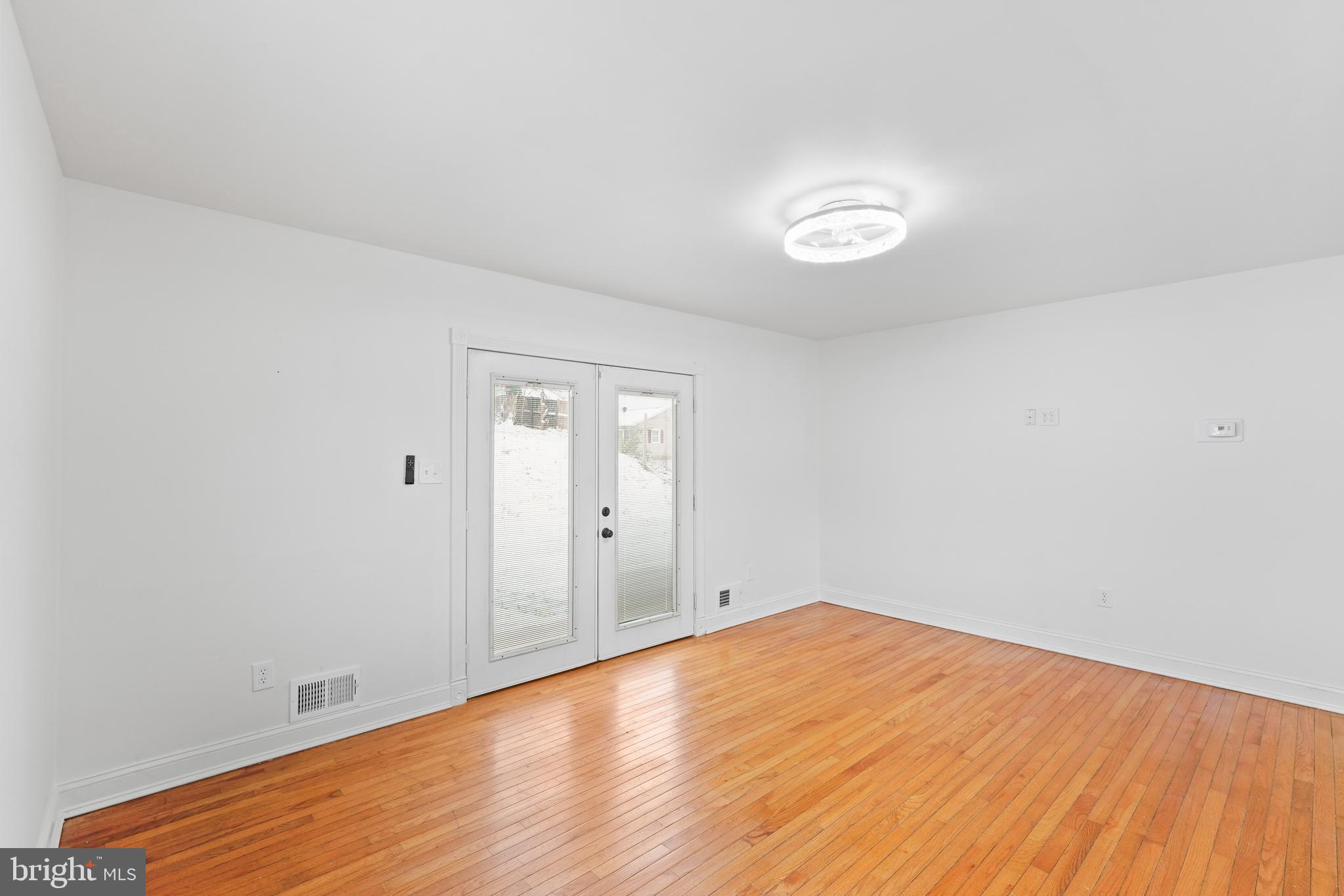 6903 Fawncrest Drive Capitol Heights, MD 20743 - Photo 16 of 36 a view of room with wooden floor and fan