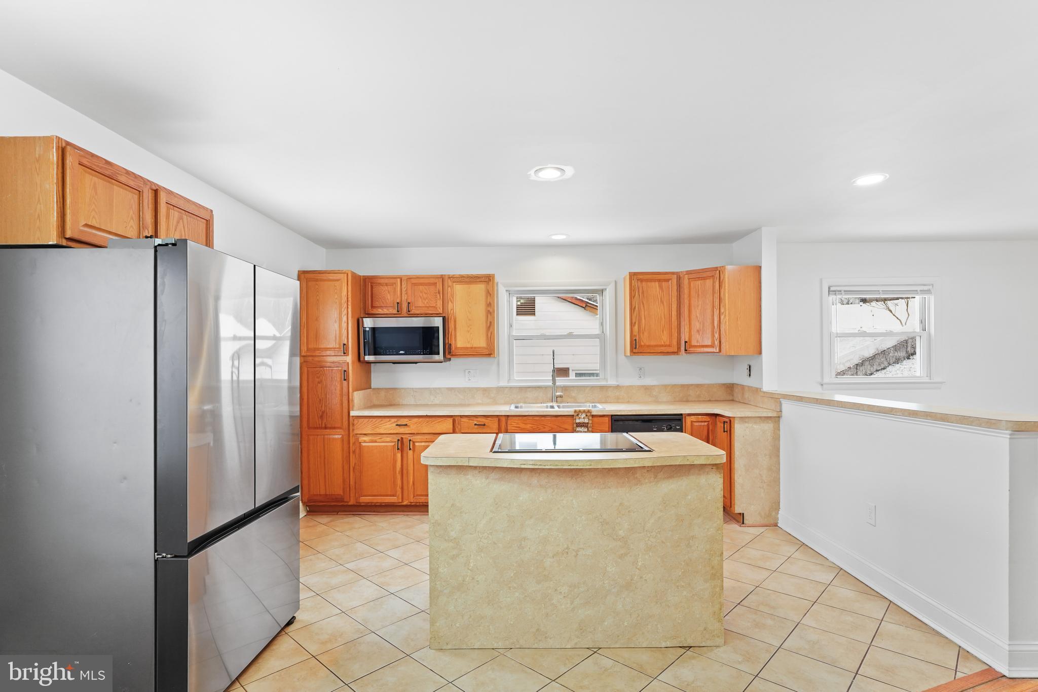 6903 Fawncrest Drive Capitol Heights, MD 20743 - Photo 18 of 36 a kitchen with stainless steel appliances granite countertop a refrigerator and a sink