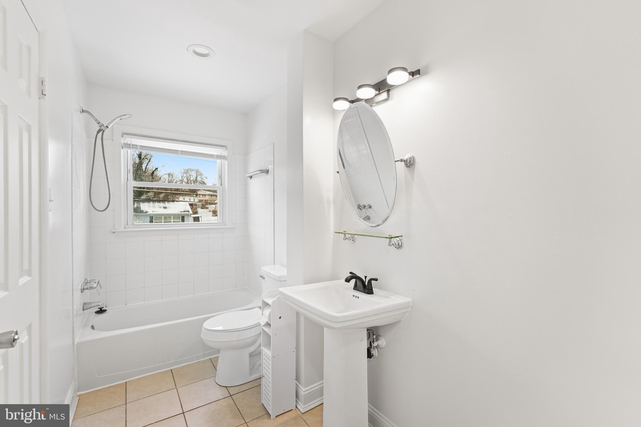 6903 Fawncrest Drive Capitol Heights, MD 20743 - Photo 30 of 36 a bathroom with a sink toilet and shower