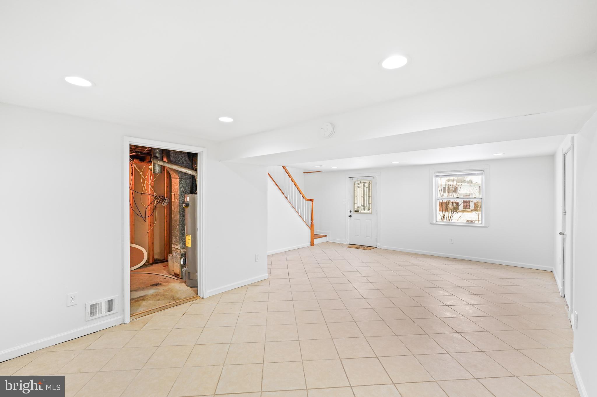6903 Fawncrest Drive Capitol Heights, MD 20743 - Photo 4 of 36 an empty room with chandelier fan and windows