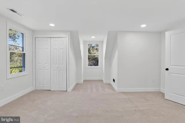 a bathroom with a granite countertop sink a toilet and a mirror