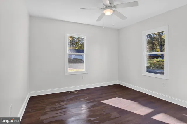 a view of an empty room with a cabinet and stairs