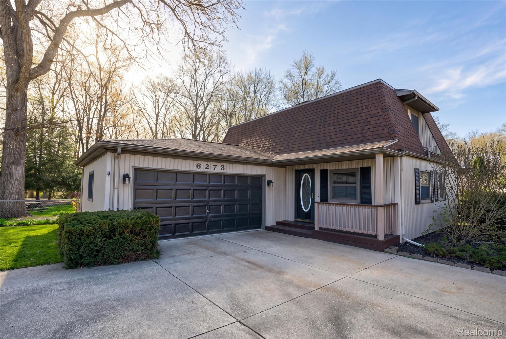 6273 Cold Spring Trail Grand Blanc, MI 48439 - Photo 2 of 48 View of front of property featuring a garage, a shingled roof, driveway, and covered porch