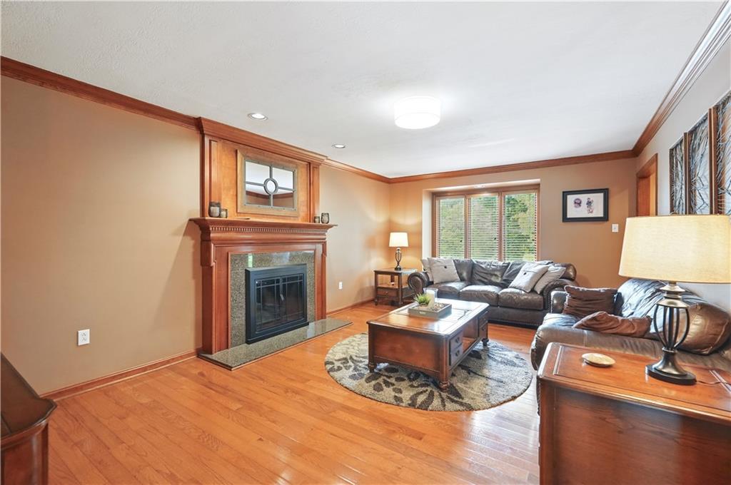 1751 Hassam Road Coraopolis, PA 15108 - Photo 17 of 50 a living room with furniture a fireplace and a large window