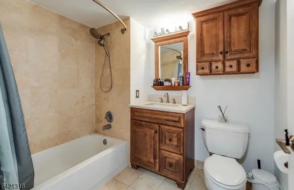 a bathroom with a toilet sink vanity tub and shower