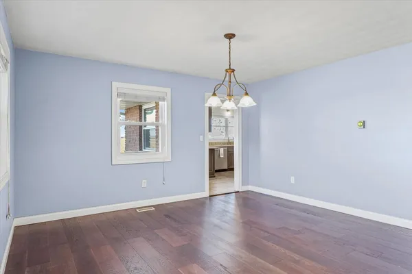 a view of a room with windows and wooden floor