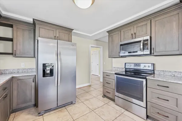 a kitchen with stainless steel appliances granite countertop a refrigerator stove and sink