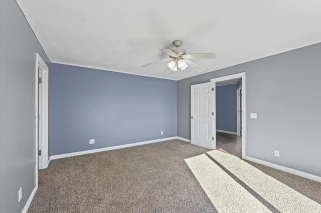 a view of an empty room with a fan