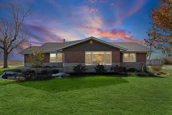a front view of a house with a garden