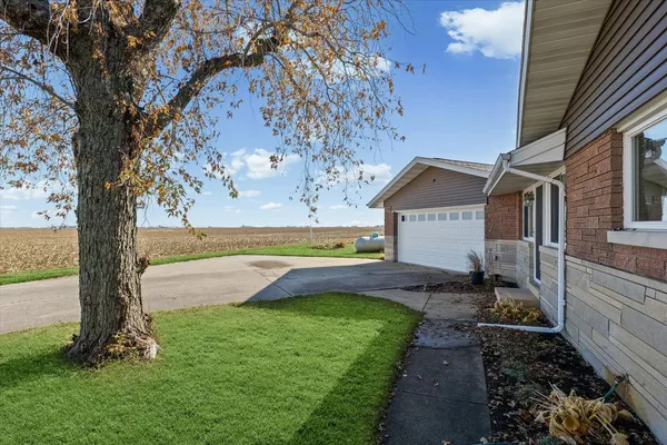 a view of backyard with barbeque grill and a small yard